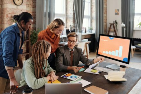 A Group of Software Engineers Collaborating, Coding on Multiple Monitors, Graduation Cap and Diploma, Career Progression Chart, Cloud Computing and AI Icons